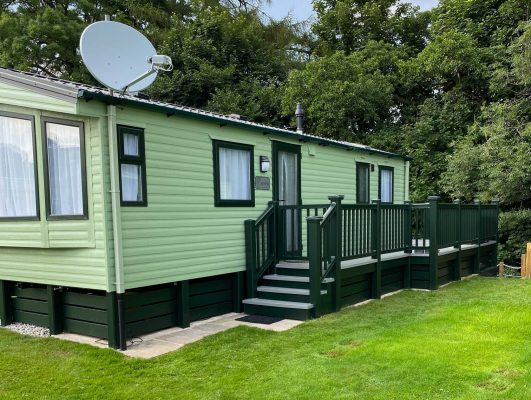 green decking walkway down the side of the caravan