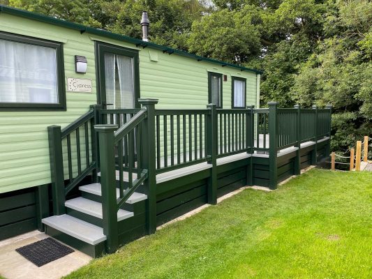 closeup view for decking idea down the side of a caravan in green