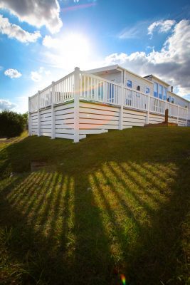 Elevated caravan deck with high plinth for the slope