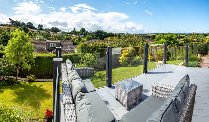 Glass veranda with dark grey posts with fields and trees